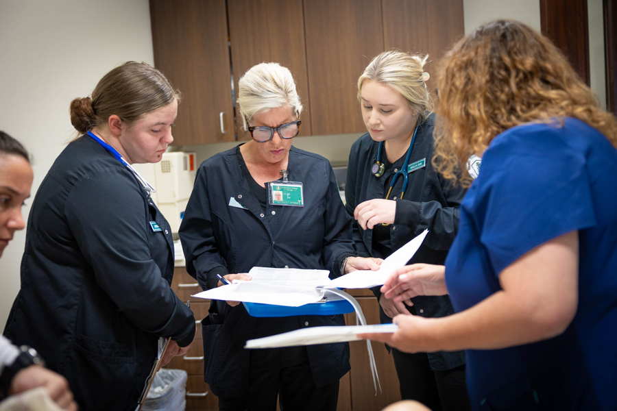 Nursing students studying documents