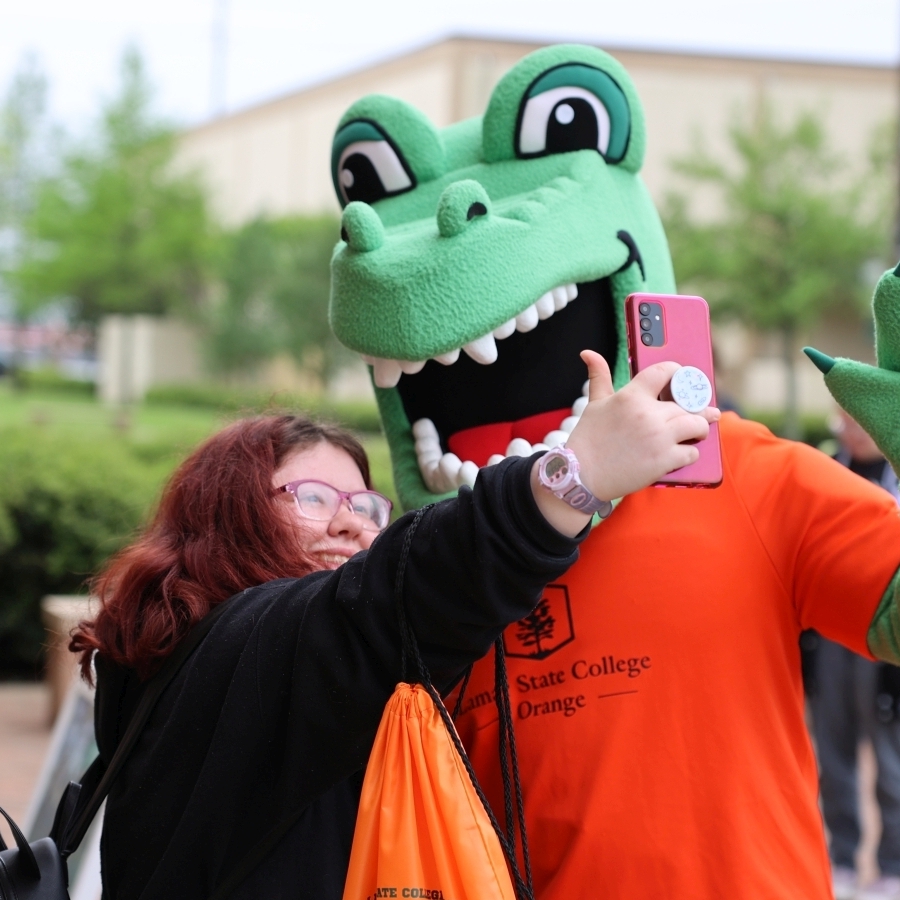 student with LSCO Gator mascott