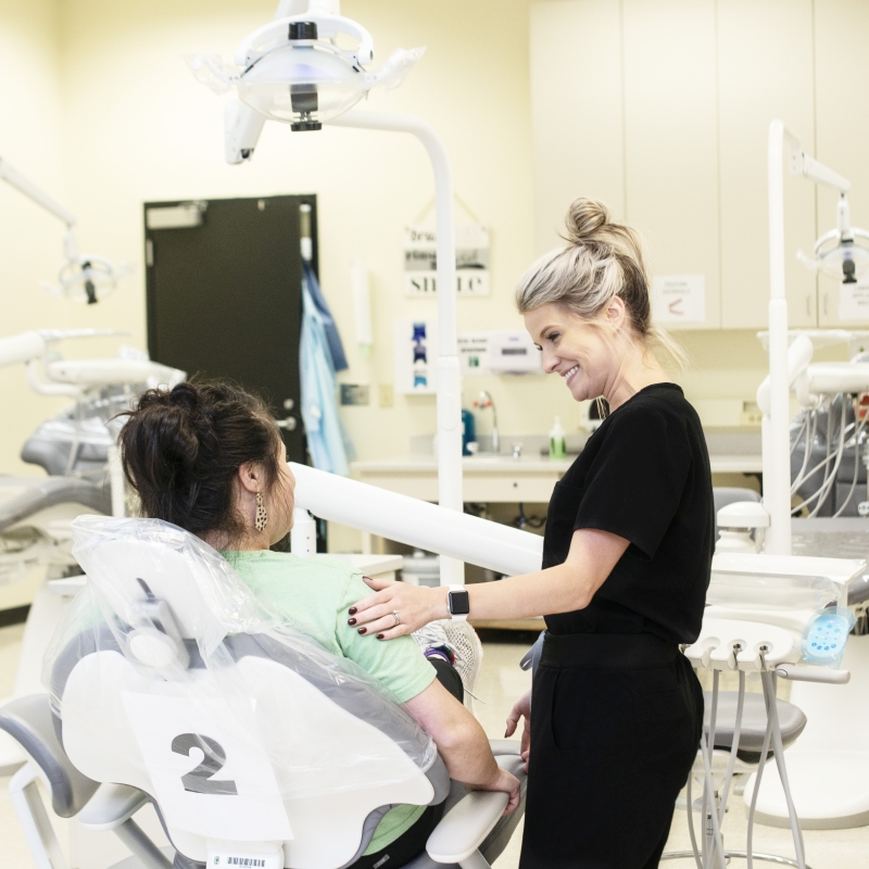 Nursing student helping patient