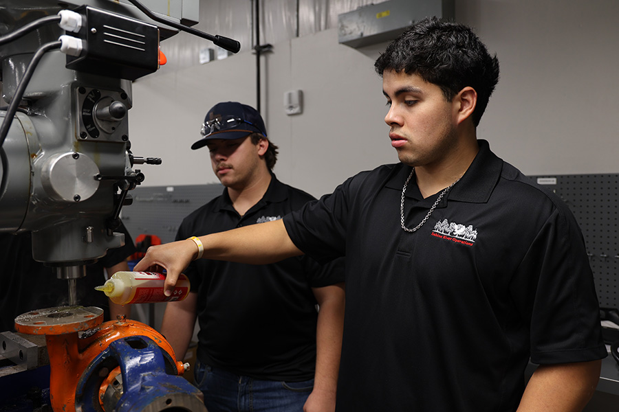 two dow apprentices lubricating rotating equipment