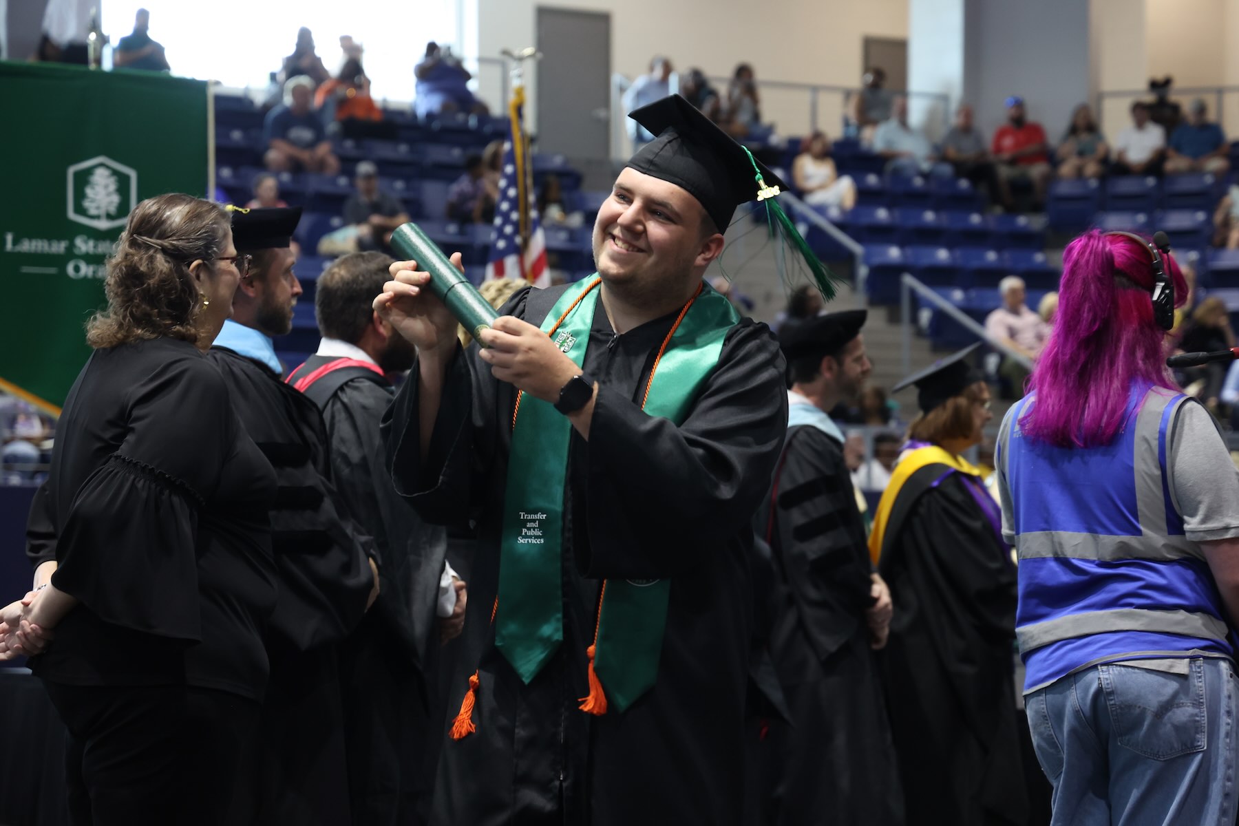 Graduate showing off degree at commencement