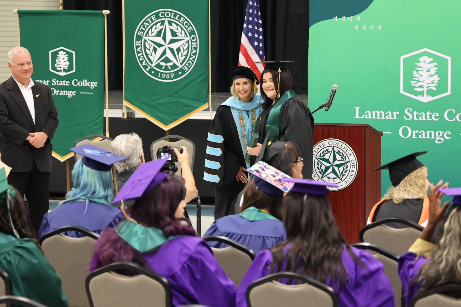 Graduate taking photo with President