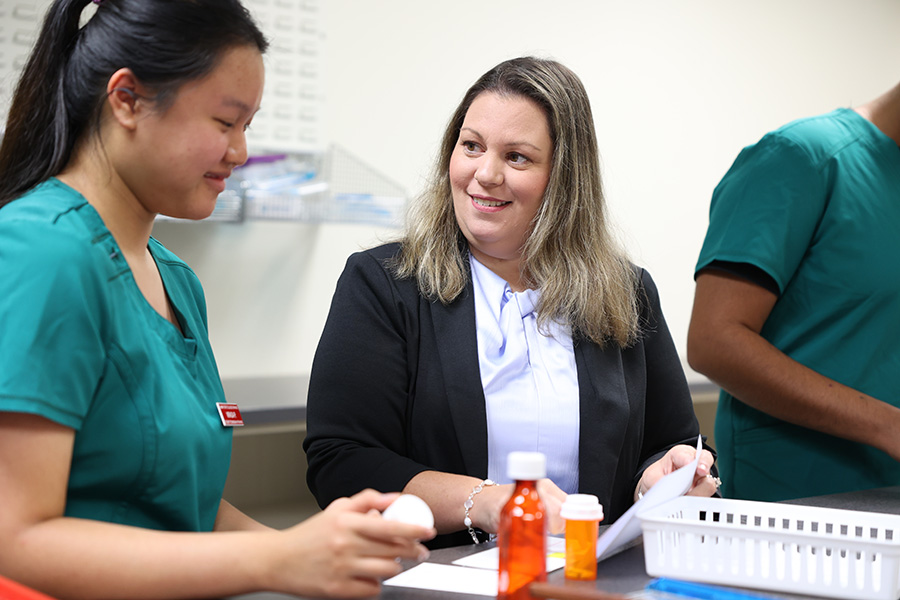 Jennifer Fabriguze assisting pharmacy technology student