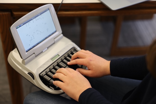 Court reporting student uses stenotype machine