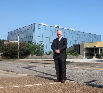 Dr. Johnson in front of Capital One building