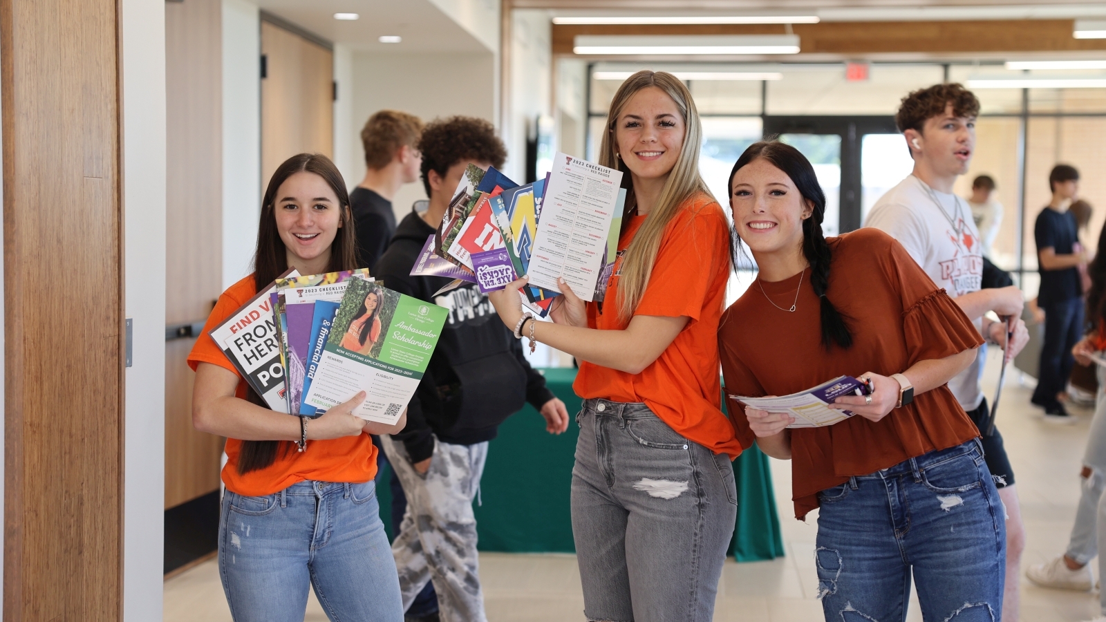 Students holding items