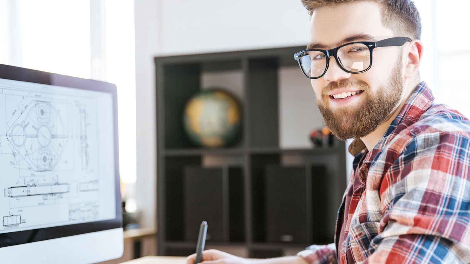 Individual sits at a desk working on a computer