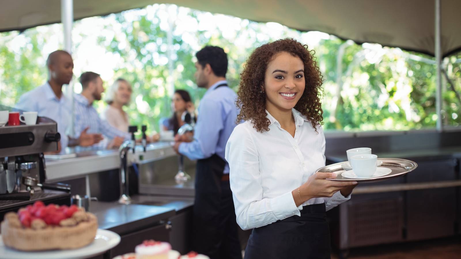 Hospitality professional carrying tray
