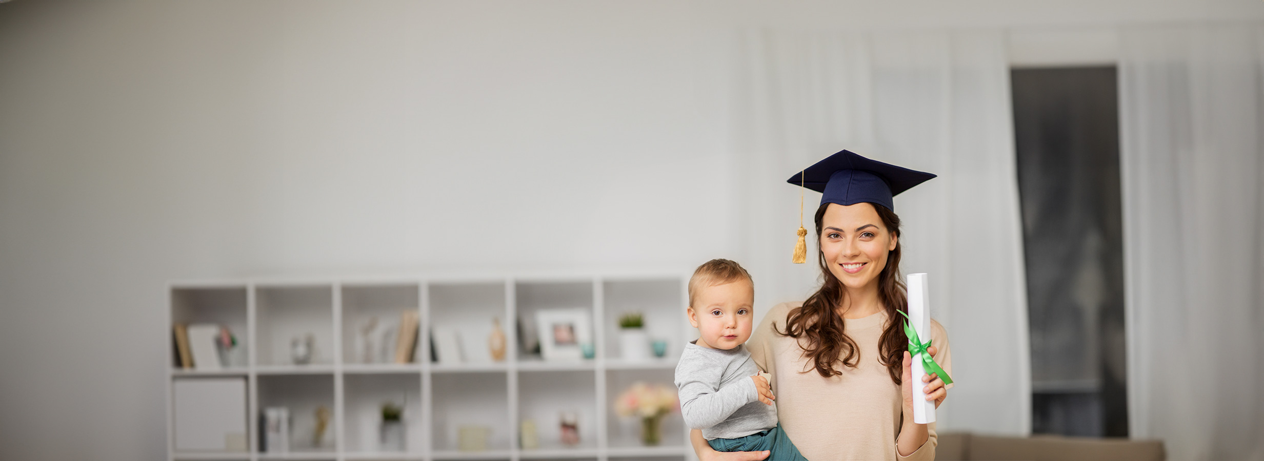 Young mother holding baby and diploma